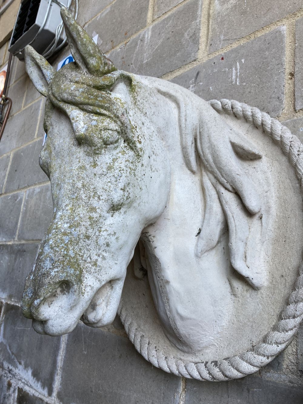 A weathered reconstituted stone model of a horses head, height 60cm